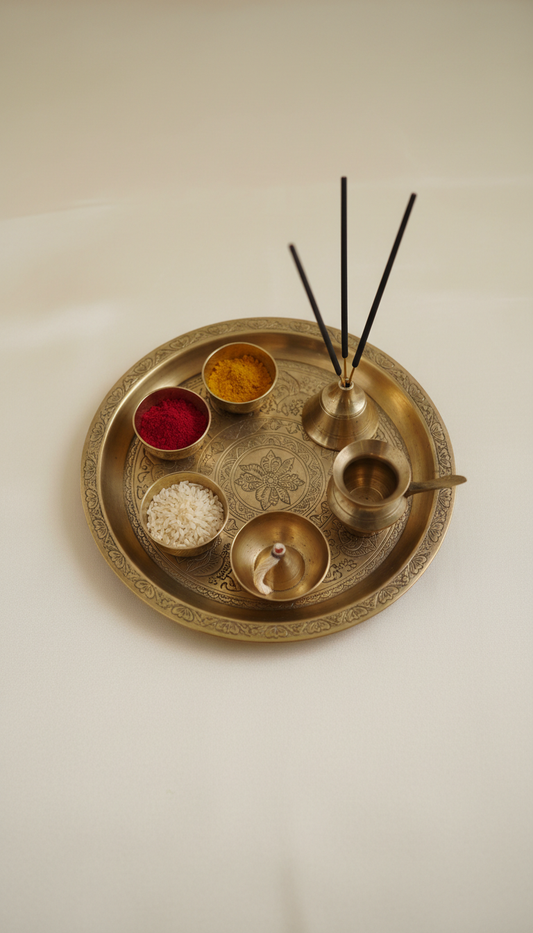 Ornate brass puja thali with ritual items